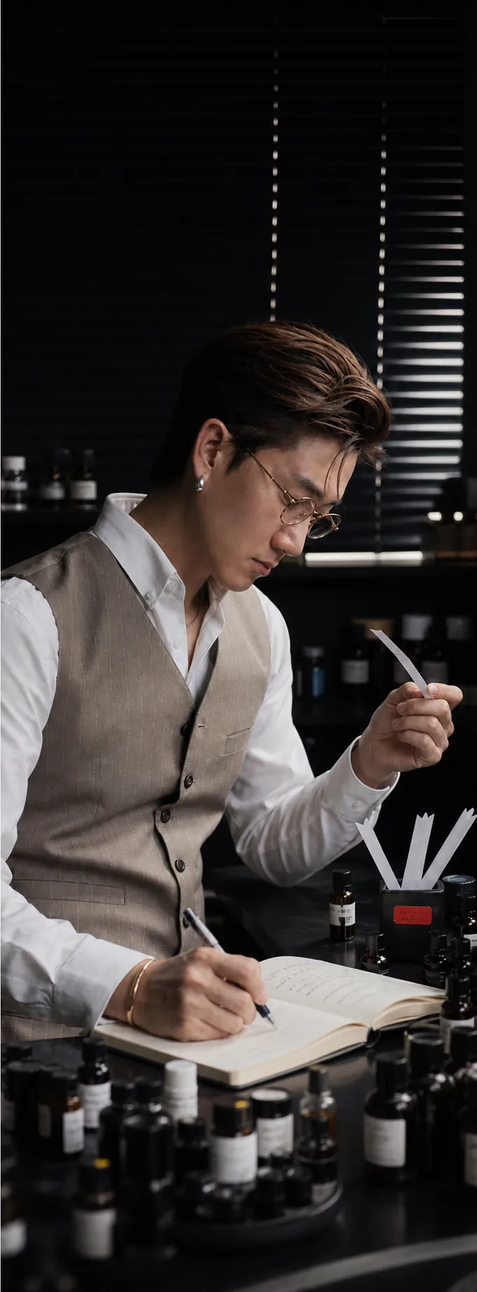 Aven Xu evaluating fragrance and recording a formula
